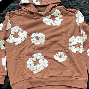 Denim Tears Brown Hoodie with White Floral Design